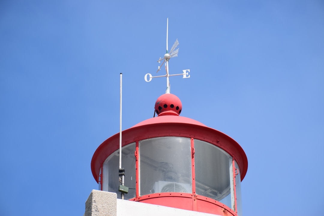 Lighthouse beacon shining through fog providing guidance and clear direction