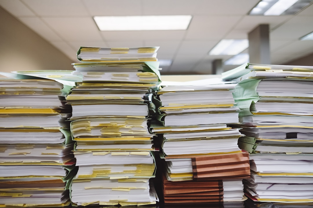 Organized stack of regulatory documents and permits displayed systematically on desk