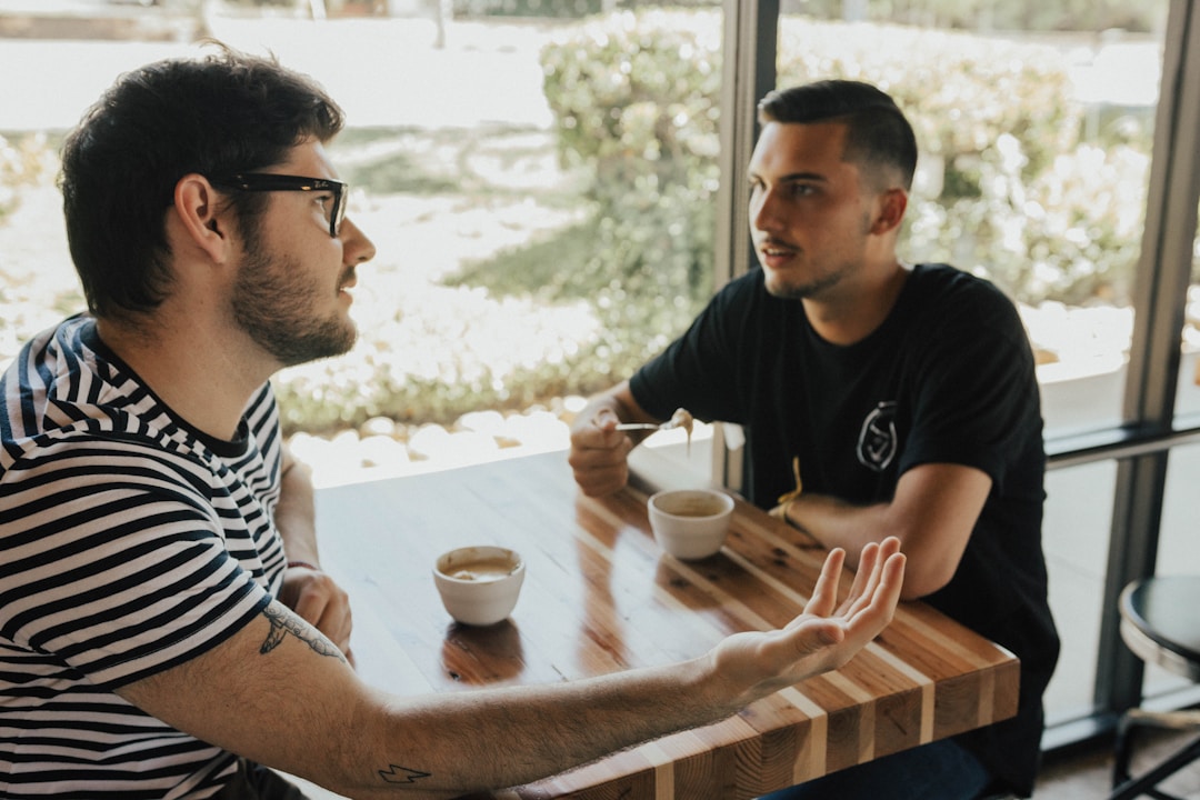 Two coworkers having serious discussion over coffee, engaged in meaningful dialogue