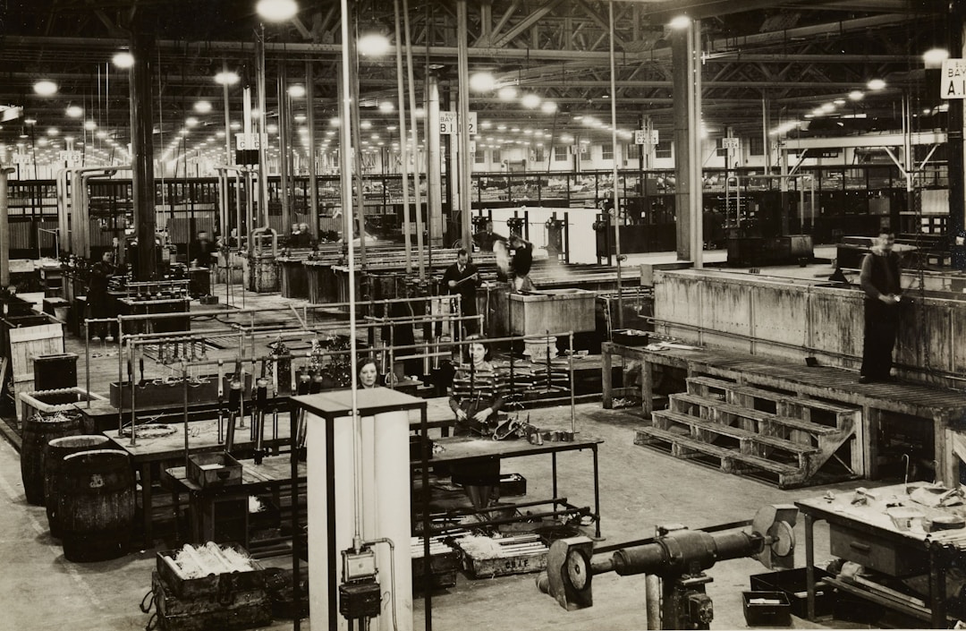 Industrial manufacturing floor with workers and equipment, illustrating operational capabilities
