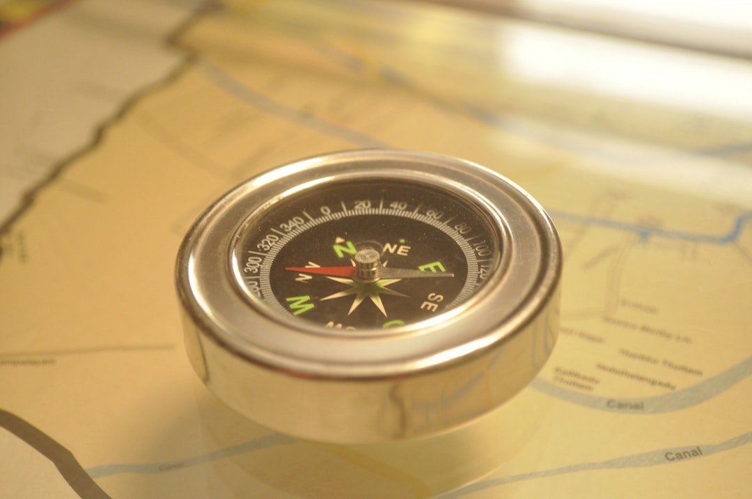 Vintage compass pointing direction with map showing strategic navigation