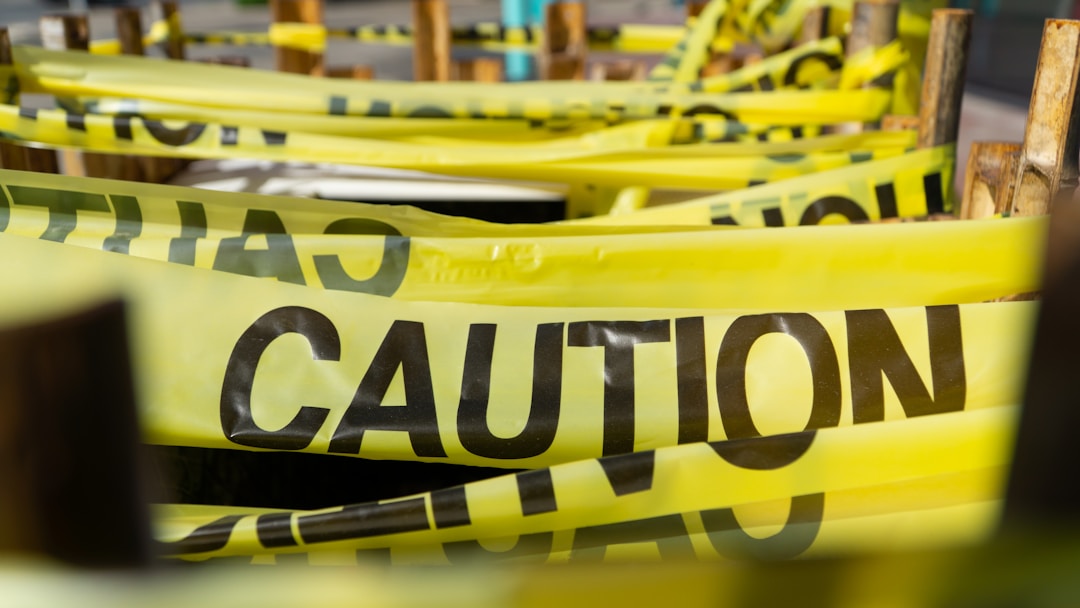 Bright yellow caution tape creating barrier pattern against neutral background