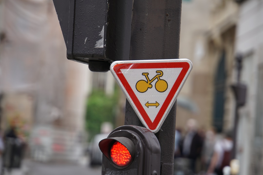 Yellow traffic light glowing against cloudy sky background