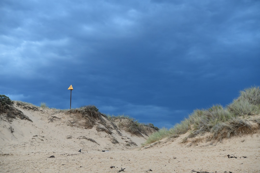 Dark storm clouds gathering over landscape representing potential business complications