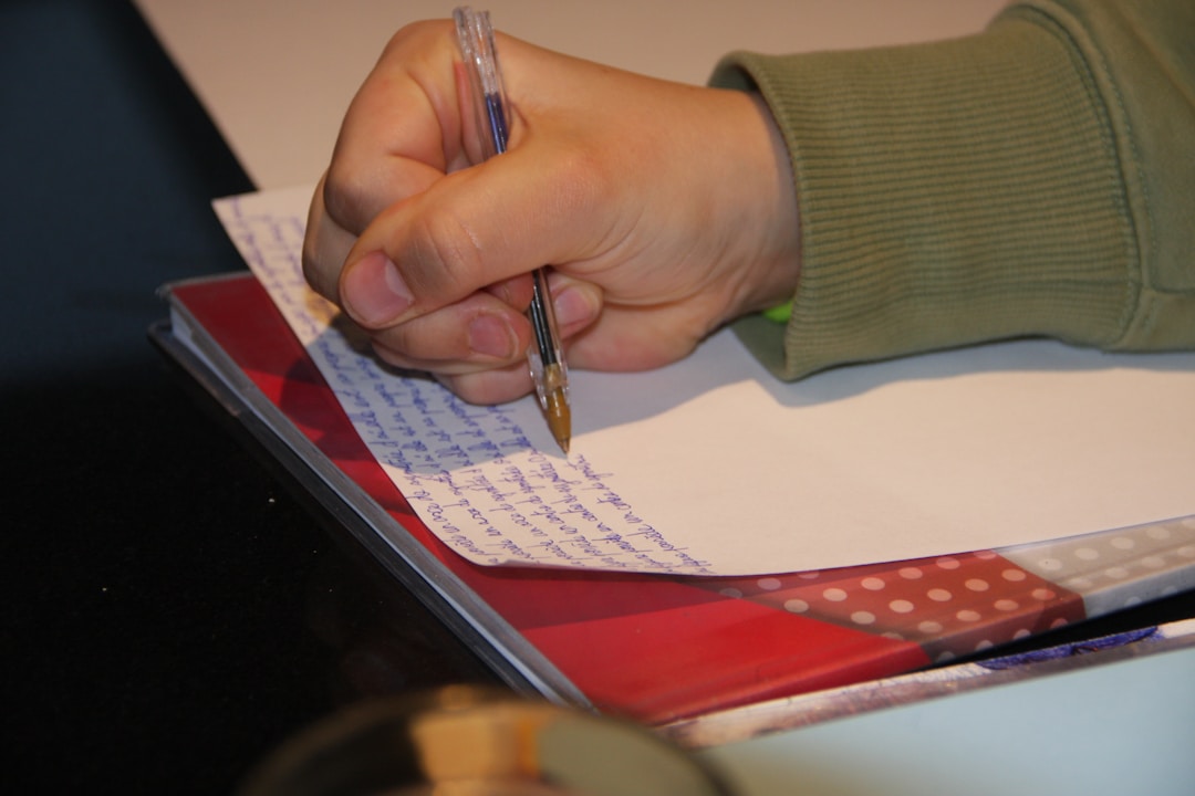 Close-up of hand signing an important business agreement document